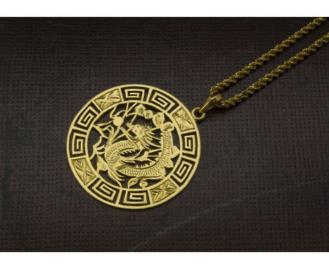 A vintage Far Eastern yellow metal pendant on chain, the circular pierced pendant with dragon in Greek key border, supported 