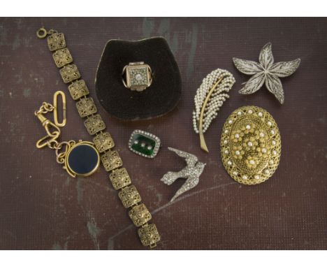 An interesting collection of jewellery and other items, presented in two jewellery box trays, including two cherry coloured b