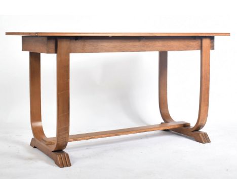 An Art Deco early 20th century circa 1930s oak extending breakfast occasional table. The table having a solid oak straight to