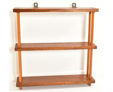 A contemporary stained beech wood peg jointed wall hanging shelf unit. The unit having three tiers with twin turned supports 