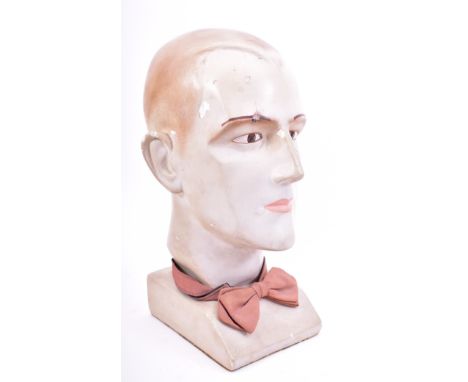 A vintage 1920s-1930s haberdashery / millinery point of display shop plaster mannequin bust head of a gent. The man with hand