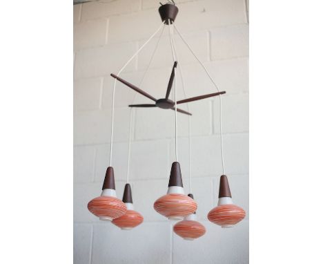 A retro mid century 1960s Danish teak hanging ceiling light. The light having a five branch propeller frame each with a hangi