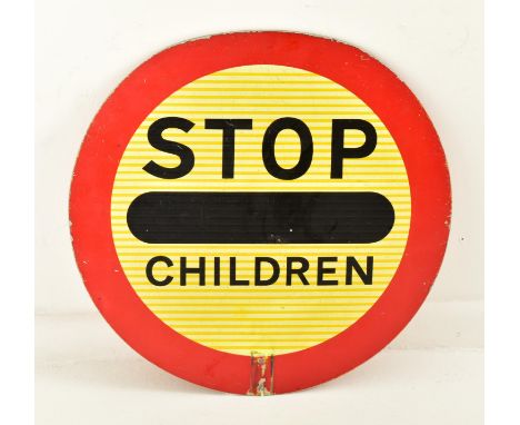 A retro 20th century traffic road motoring car lollipop enamel round sign reading ' Stop Children ' . Round red &amp; yellow 