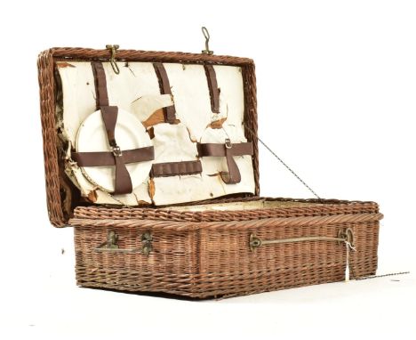 An early 20th century circa 1920s six person Coracle wicker picnic basket. The basket opening to reveal a fully appointed int