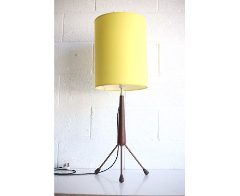 A retro 20th century 1960s teak tripod table lamp light. The lamp having a chrome fitting and new yellow shade supported by a