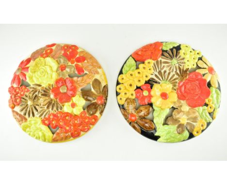 Two early - mid 20th century Art Deco circa 1930s ceramic autumnal floral wall chargers. Each with bright perforated floral d