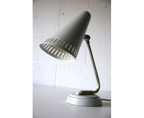 A large 20th century 1950s German designer desk / table lamp light. The lamp having a conical grey shade with perforated rim.