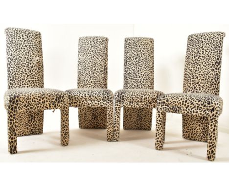 A set of four vintage late 20th century upholstered high back dining chairs. Each chair in a leopard print upholstered fabric