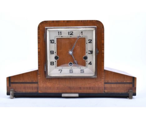 An Art Deco style mid century walnut Westminster chime mantlepiece clock. The mantle clock of walnut and chrome, in Cubist st