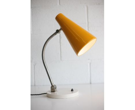 A vintage 20th century 1950s desk / table lamp light. The lamp having a vibrant yellow conical shade supported by a sweeping 