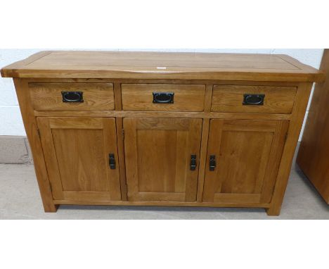 A modern light elm sideboard of 3 cupboards and 3 drawers