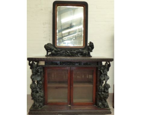 A 19th century oriental carved hardwood display cabinet in the Chinese manner with rectangular mirror back in carved parcel g