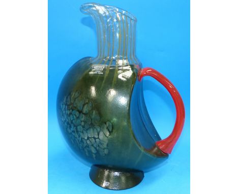 A Kosta Boda streaked green glass jug with red loop handle, signed to base 'K Engman', 11.5"