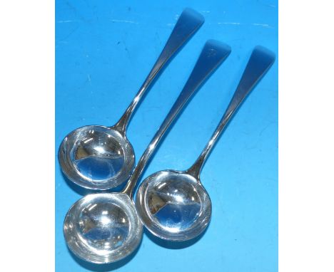 A pair of Georgian Old English pattern sauce ladles, London 1824; a larger ladle, London 1820, 6½ oz.