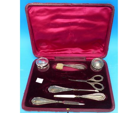 A cased manicure set with twin silver top trinket jars, Birmingham 1909 (incomplete)