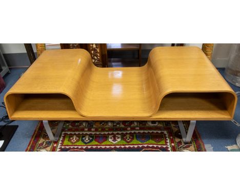 A 20th century teak heat-moulded stylish coffee table on metal supports with two compartments for magazines.