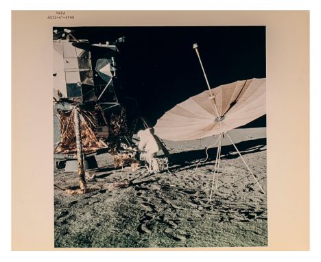 Apollo 12 mission Nasa code AS12-47-6988Astronaut Charles Conrad stands at Modular Equipment Stowage Assemble20 x 25 cm.Start