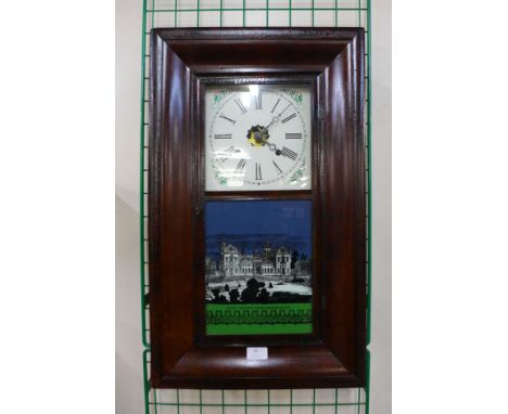 A 19th Century American Waterbury Clock Co. mahogany ogee wall clock 