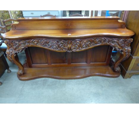 A Rococo style carved mahogany serpertine console table 