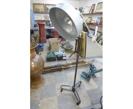 An industrial steel anglepoise lamp on wheels 