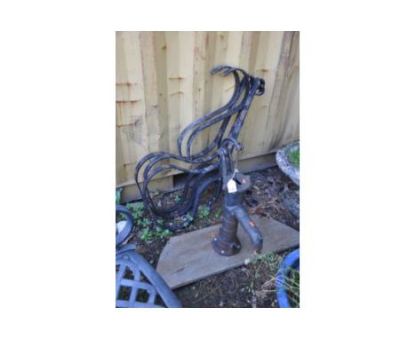 A VINTAGE CAST IRON WATER PUMP mounted on a wooden plank, height 67cm and a vintage wrought flat iron bench frame consisting 