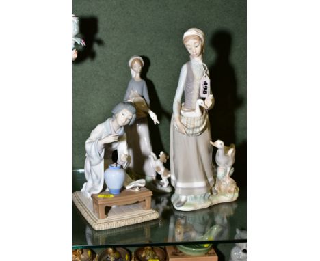 THREE LLADRO FIGURINES, comprising a girl with a goose and a puppy jumping up, height 26.5cm, a girl with a gosling in her ap