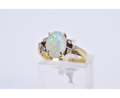 A MODERN OPAL AND DIAMOND DRESS RING, opal measuring approximately 10mm x 7.5mm (condition: small chip to the girdle), estima