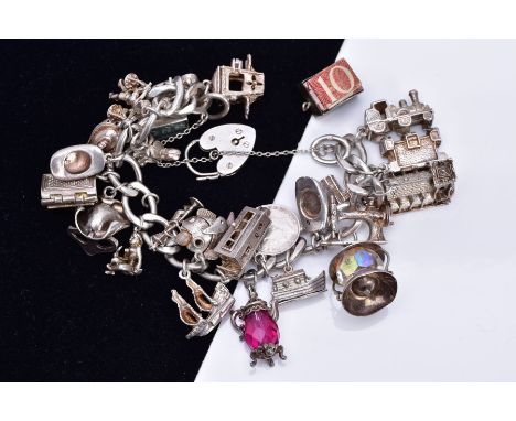 A SILVER CHARM BRACELET, suspending twenty-four charms such as a hinge open church, opens to reveal holy water bowl, boat, la