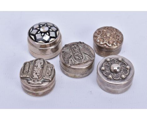 A COLLECTION OF FIVE ASSORTED WHITE METAL SMALL ROUND PILL BOXES, various designs to include enamel work, Egyptian symbols an