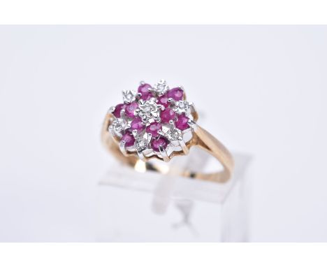 A 9CT GOLD RUBY AND DIAMOND CLUSTER RING, of tiered design, illusion set single cut diamonds and circular cut rubies, tapered