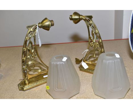 A PAIR OF BRASS ART NOUVEAU STYLE ELECTRIC WALL LIGHTS, with a pair of Art Deco satin glass style lamp shades, length of arm 