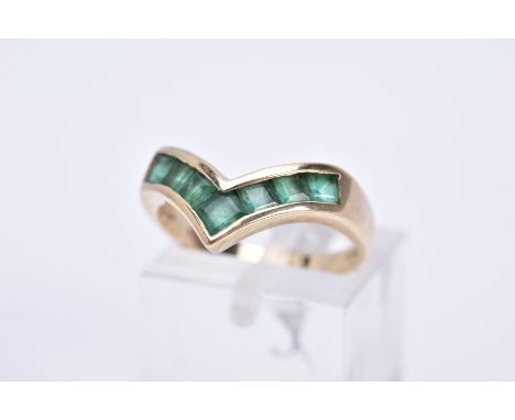 A 9CT GOLD EMERALD RING, of 'v' shape design set with square cut emeralds, plain polished band, hallmarked 9ct gold Sheffield