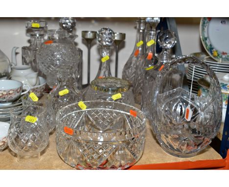 A GROUP OF MOSTLY CUT GLASS ITEMS, to including five decanters, a ships decanter a candle holder with shade, a basket, a stra