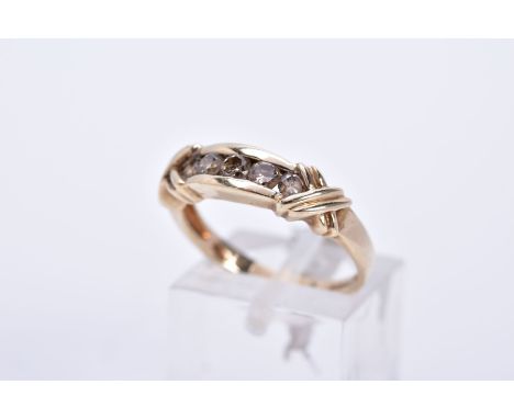 A 9CT GOLD FIVE STONES DIAMOND RING, designed with five graduated round brilliant cut diamond, rub over mount, cross detailed