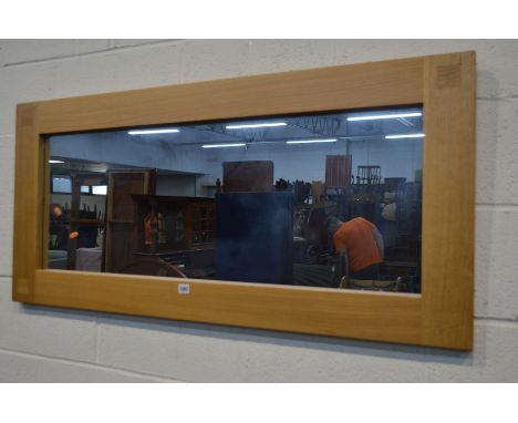 A LIGHT OAK FRAMED RECTANGULAR WALL MIRROR, 130cm x 60cm