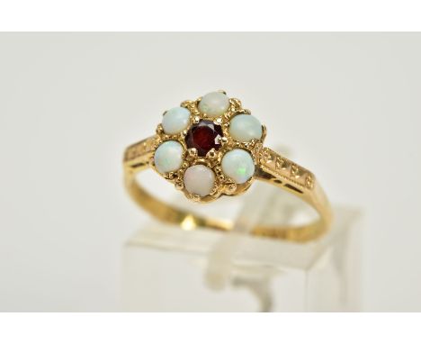 A 9CT GOLD OPAL AND GARNET CLUSTER RING, deigned with a central circular cut garnet, circular cut opal cabochon surround, det