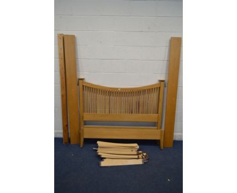 A WILLIS AND GAMBIER LIGHT OAK 4'6'' SPINDLED BED FRAME, with side rails (multiple plastic holders missing from slats)
