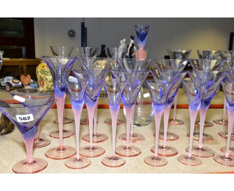 A GROUP OF STUDIO GLASS, WINE GLASSES, ETC, having pink stems and foot, holding blue bowls, including champagne flutes, wine 