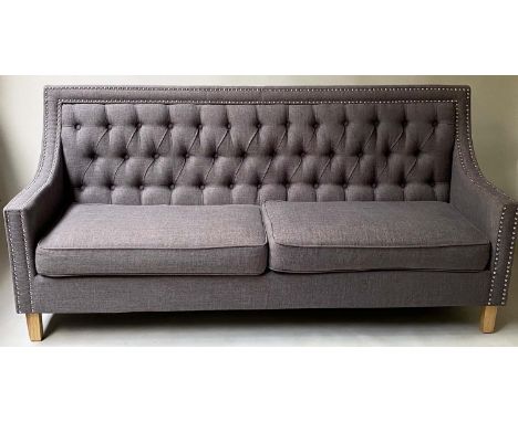 SOFA, contemporary chromium studded grey fabric upholstered and tapering oak support, 196cm W. 