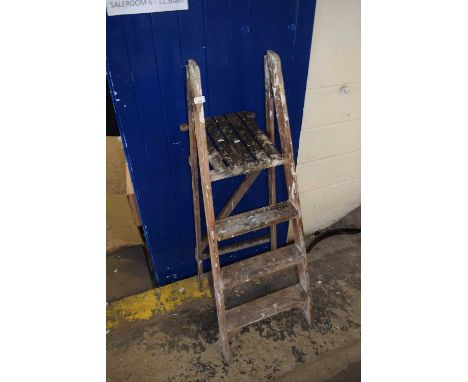 A folding wooden step ladder