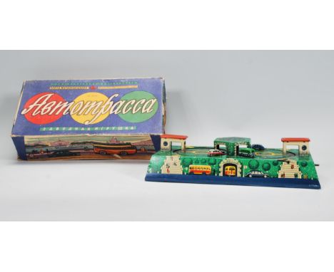 A mid 20th Century 1950's Russian tin plate&nbsp;clockwork toy with cars and buses circuiting through a tunnel and petrol gar