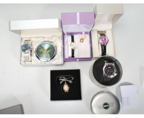 A collection of five unused boxed ladies dress wristwatches to include examples by Mini, Limit with a gold metal heart pendan