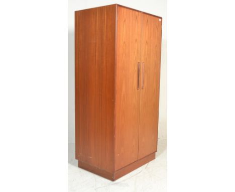 A vintage retro G Plan red label free standing wardrobe having twin doors with lipped and recessed handles the interior havin