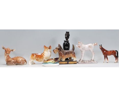 A collection of ceramic animal figurines to include a Beswick dog, a lustre fish ashtray, Scottie dog table lamp etc