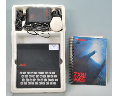 A retro original 20th Century Sinclair ZX 81 Spectrum personal home computer console with instruction manual and transformer.