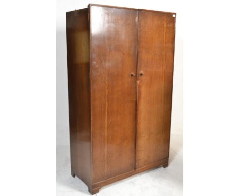 A 1930's bachelors wardrobe compactum having a fully appointed interior, mirror to inside, makers label for Excelsall Product