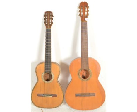 A vintage Spanish&nbsp;six string acoustic guitar having mother of pearl inlaid borders and tuning pegs and ebonised fretboar