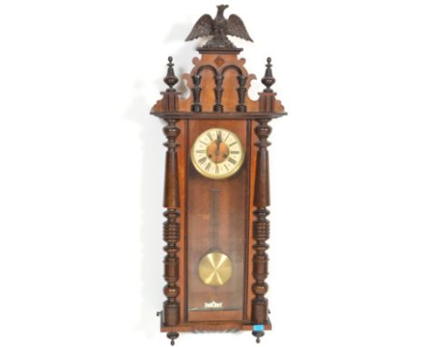 A 19th Century Victorian walnut cased Vienna regulator wall clock in the manner of Gustav Becker, the case surmounted by an e