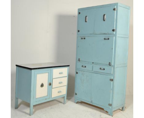 A vintage mid 20th Century kitchen unit having flared enamel work top over a bank of three drawers and single door raised on 