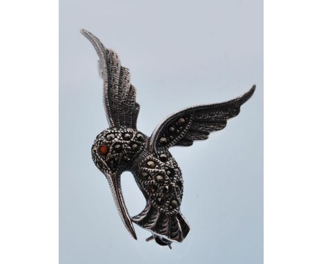 A silver and marcasite brooch in the form of a hummingbird set with a ruby eye. Stamped 925 to verso. Gross weight 4.6g. Meas